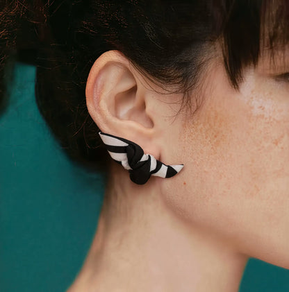 Close up of Papillon silk knot earring on ear