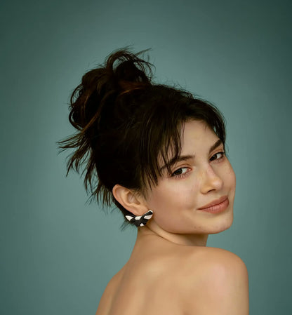 Model over the shoulder wearing Papillon earrings