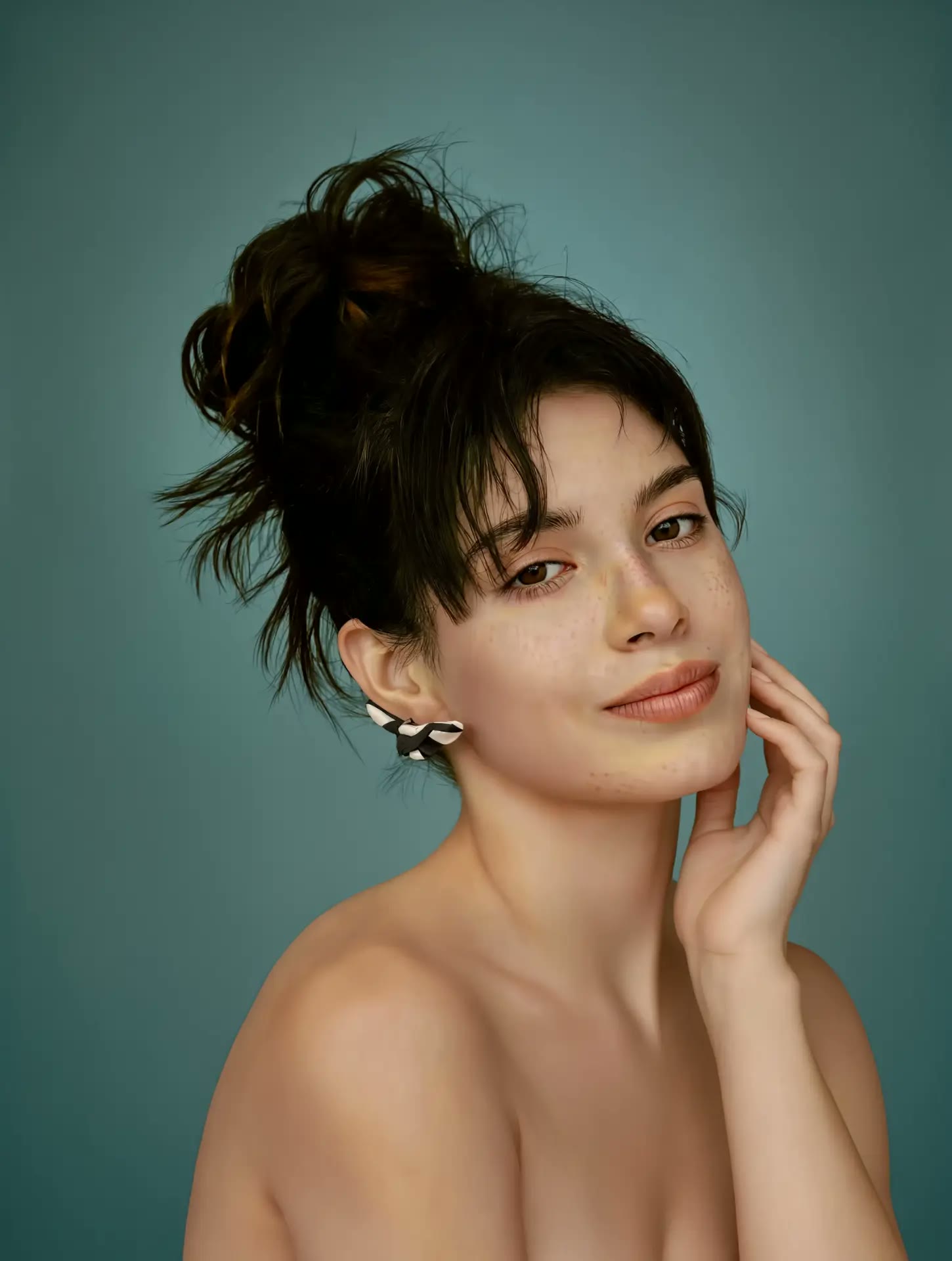 Model with hand near face wearing Papillon earrings